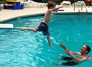 child jumps-off-diving-board